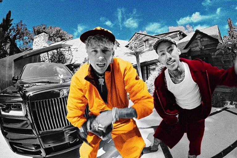 Machine Gun Kelly in an orange jumpsuit and Yuki Chiba in red, shot in fisheye over a black-and-white driveway scene, for “JJK”