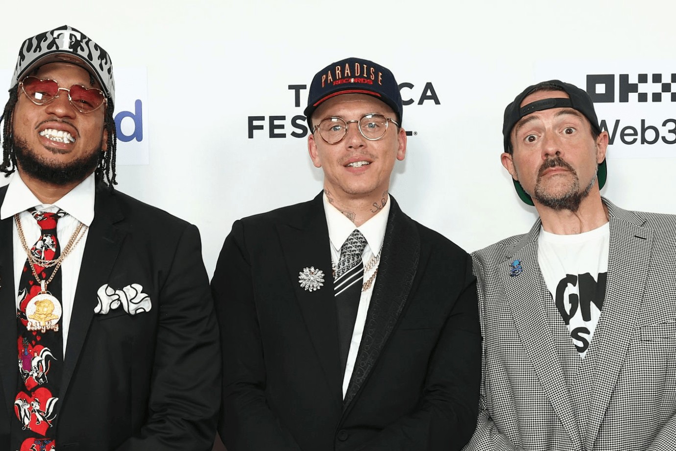 Logic, wearing a Paradise Records cap and a black suit, poses on the red carpet at the Paradise Records premiere during the 2025 Tribeca Festival