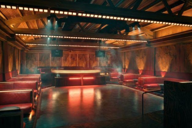 Rendering of the ORIGIN Los Angeles indoor room, a warm-lit club interior with red leather banquettes, a curved central bar, exposed wood-slat ceiling and linear light bars over a polished concrete dance floor