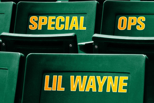 Cover art for Lil Wayne single Special Ops: rows of empty dark green stadium seats with SPECIAL OPS and LIL WAYNE stencilled across them in gold and yellow block lettering