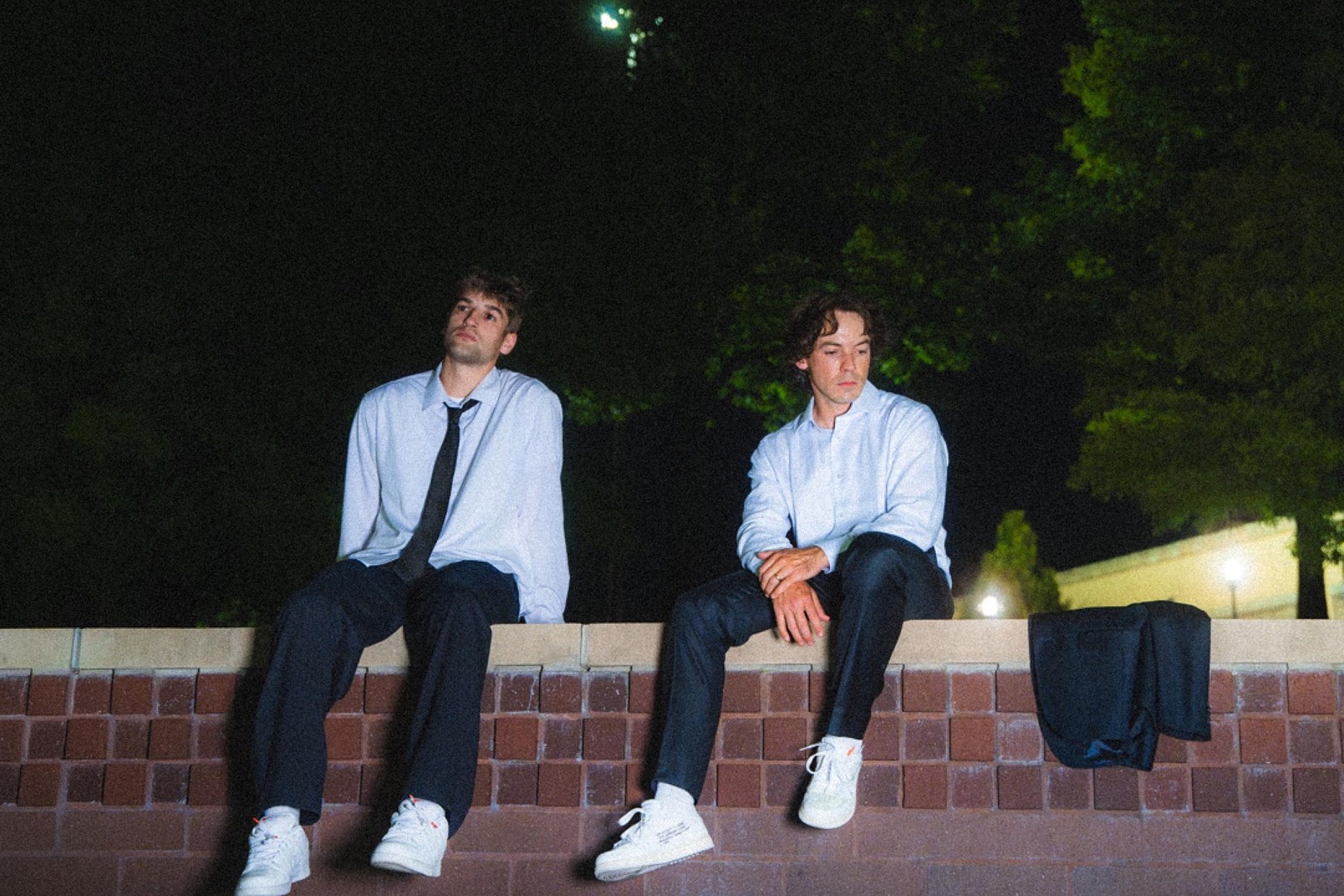 Cover art for Connor Price and GRAHAM single Zero to Hero, the two seated on a low brick wall at night in white dress shirts and dark trousers