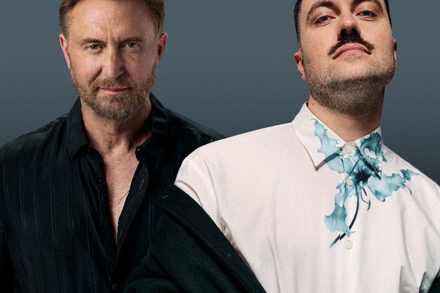 David Guetta in a black shirt and Marlon Hoffstadt in a white shirt with a blue floral print, side by side against a dark grey backdrop